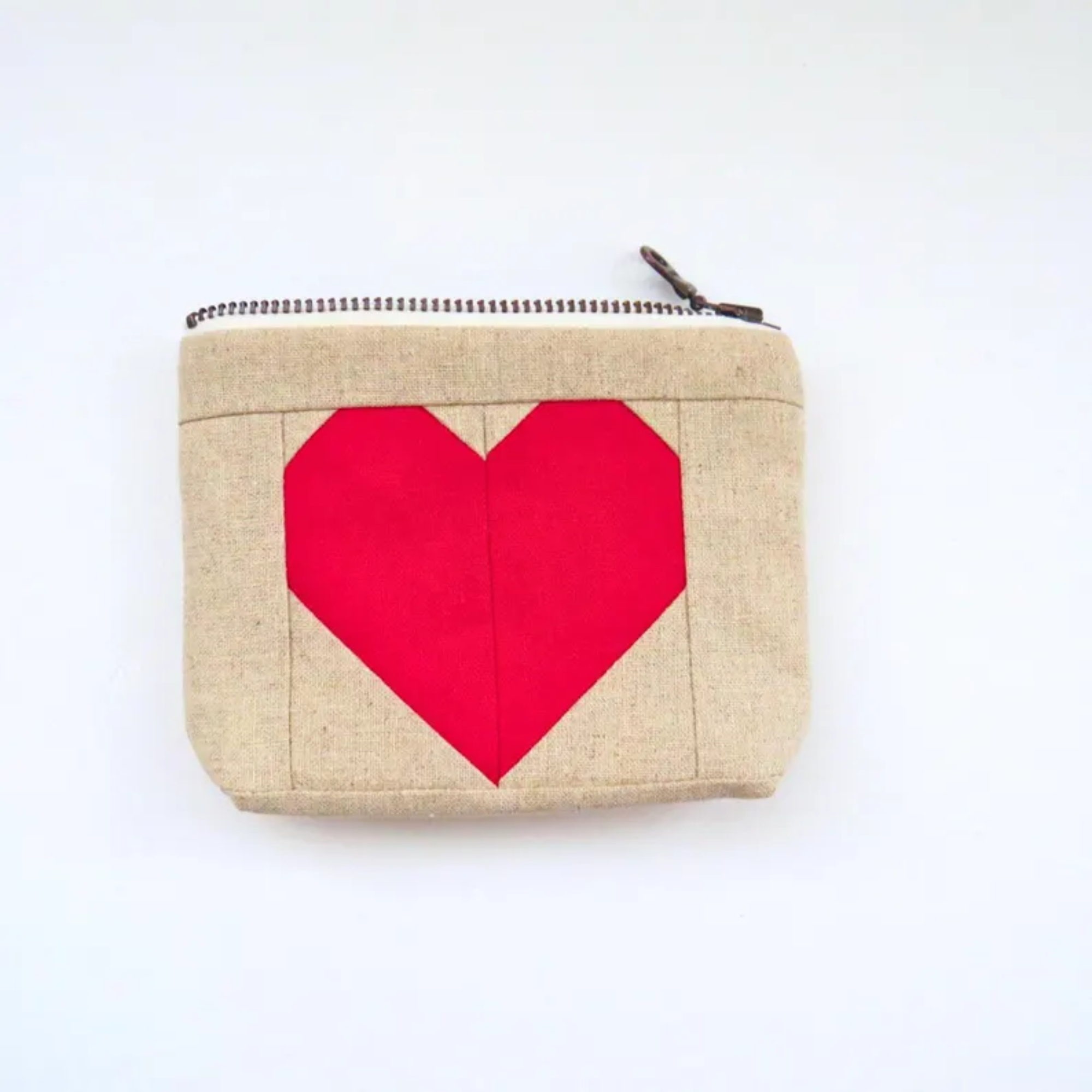Beige pouch with a red heart on a white background