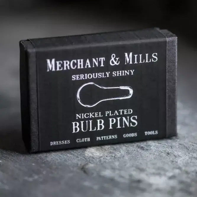 Black box of Merchant & Mills Seriously Shiny Nickel Plated Bulb Pins on a dark background