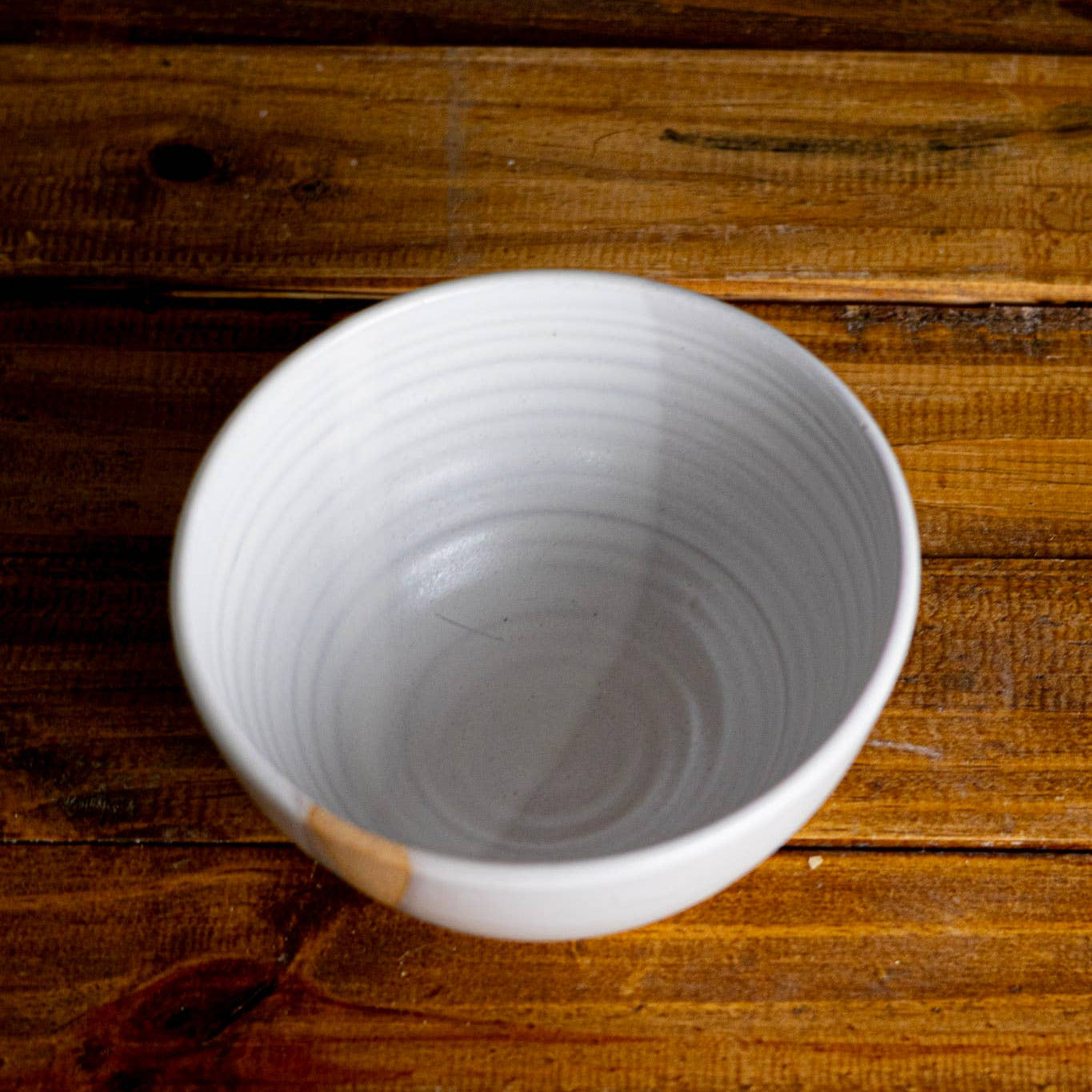 White ceramic bowl on a wooden surface
