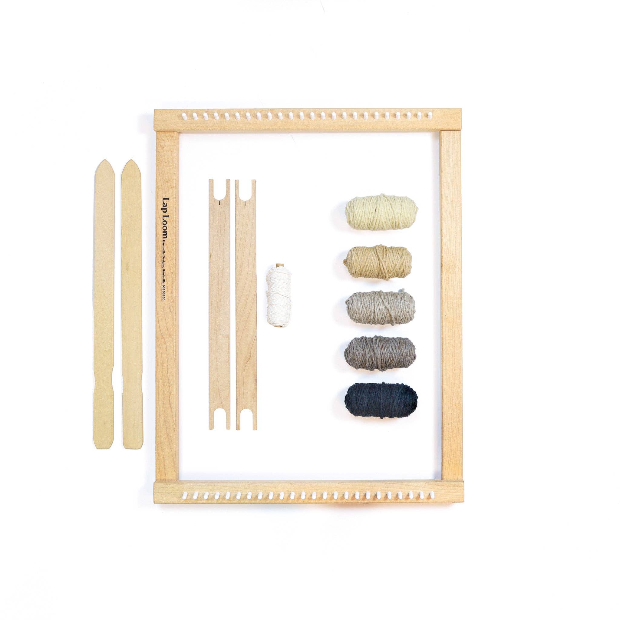 Set of wooden knitting needles and yarn on a white background