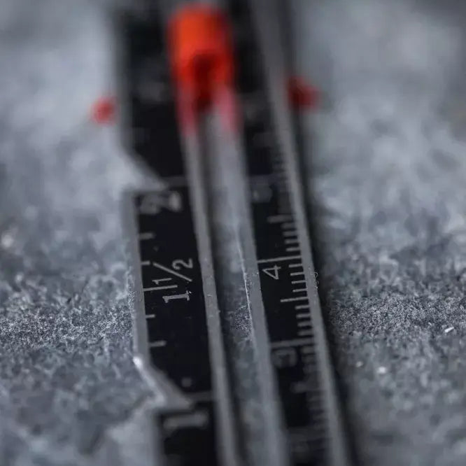 Close-up of a ruler with measurement markings on a textured surface