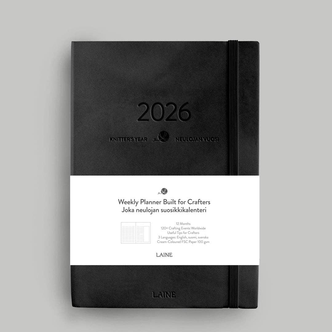 Black planner with '2026' on a gray background