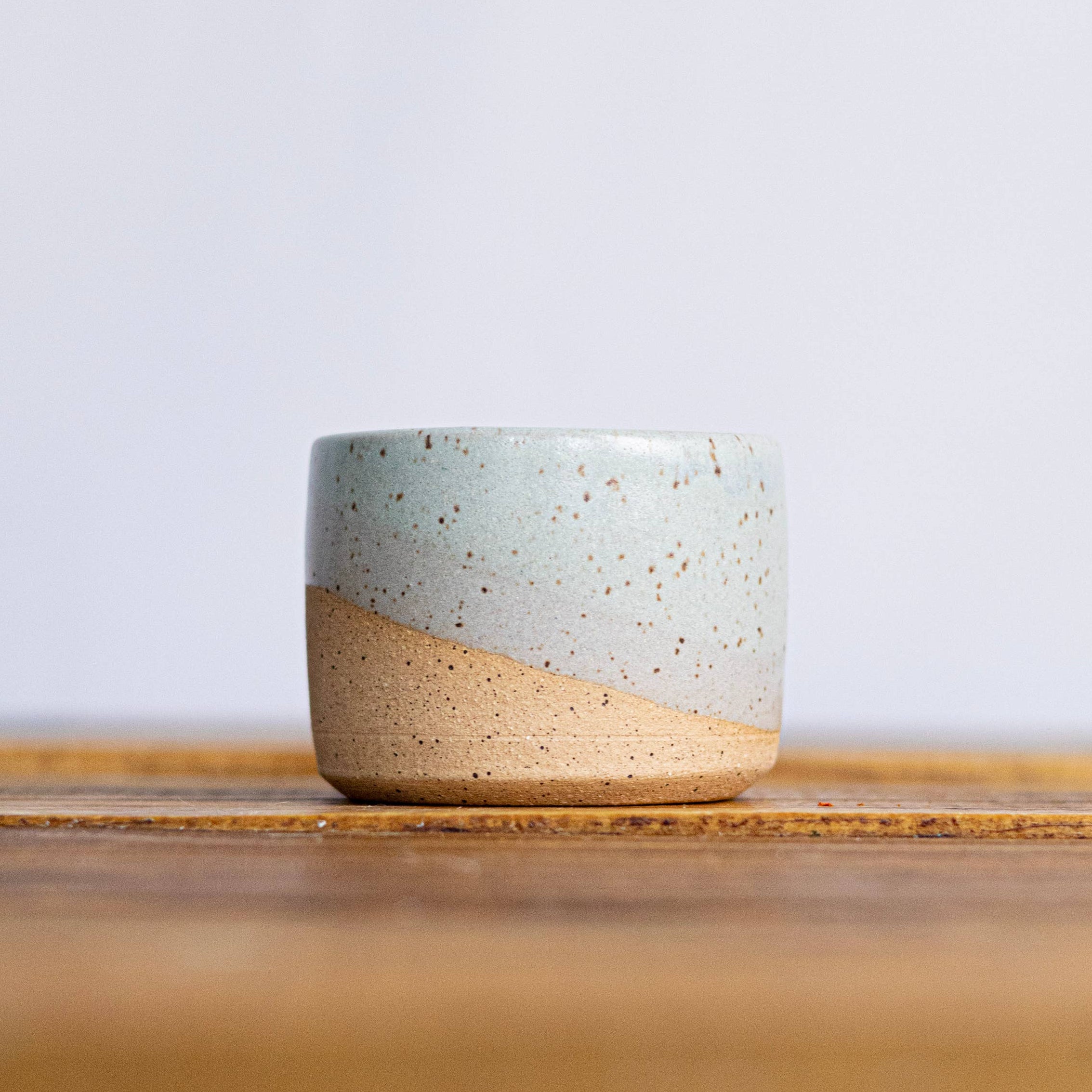 Ceramic bowl with two-tone design on a wooden surface