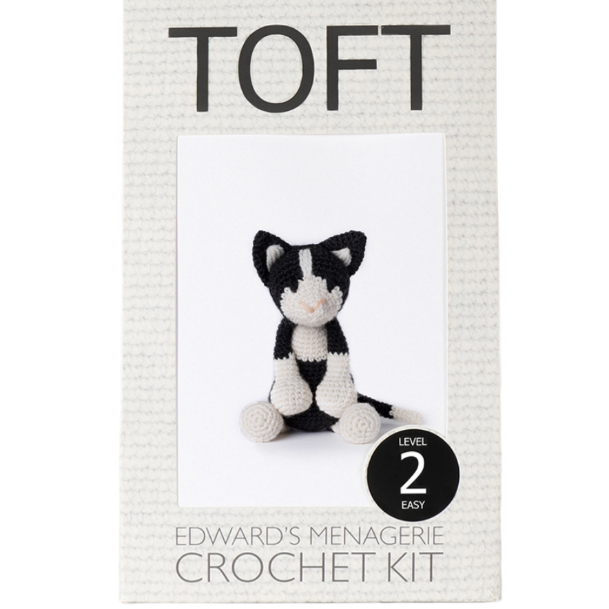 TOFT crochet kit packaging with a black and white cat toy illustration on a white background