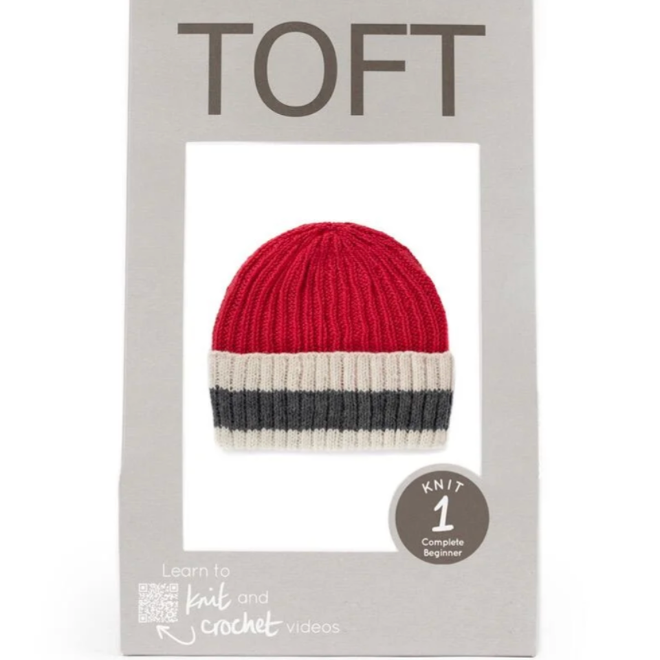 Packaged knit hat with red, white, and gray stripes on a white background