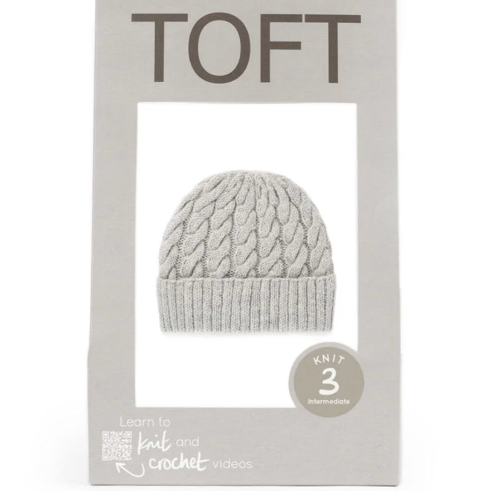 Gray knit hat in TOFT packaging on a white background