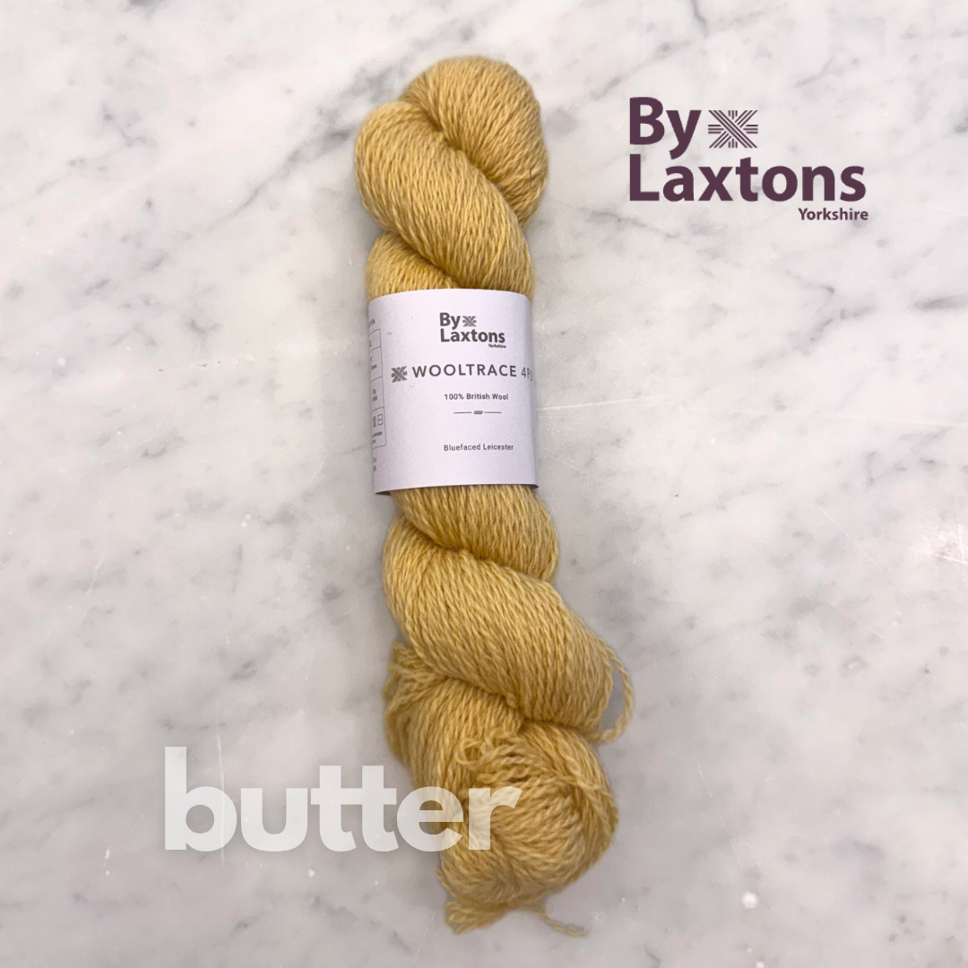 Yellow skein of yarn with a Laxton's label on a marble background