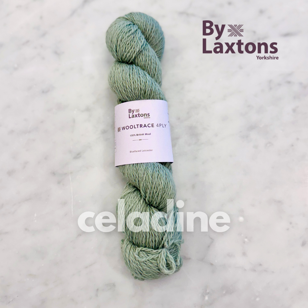 light sage Green skein of yarn with a By Laxtons label on a marble background
