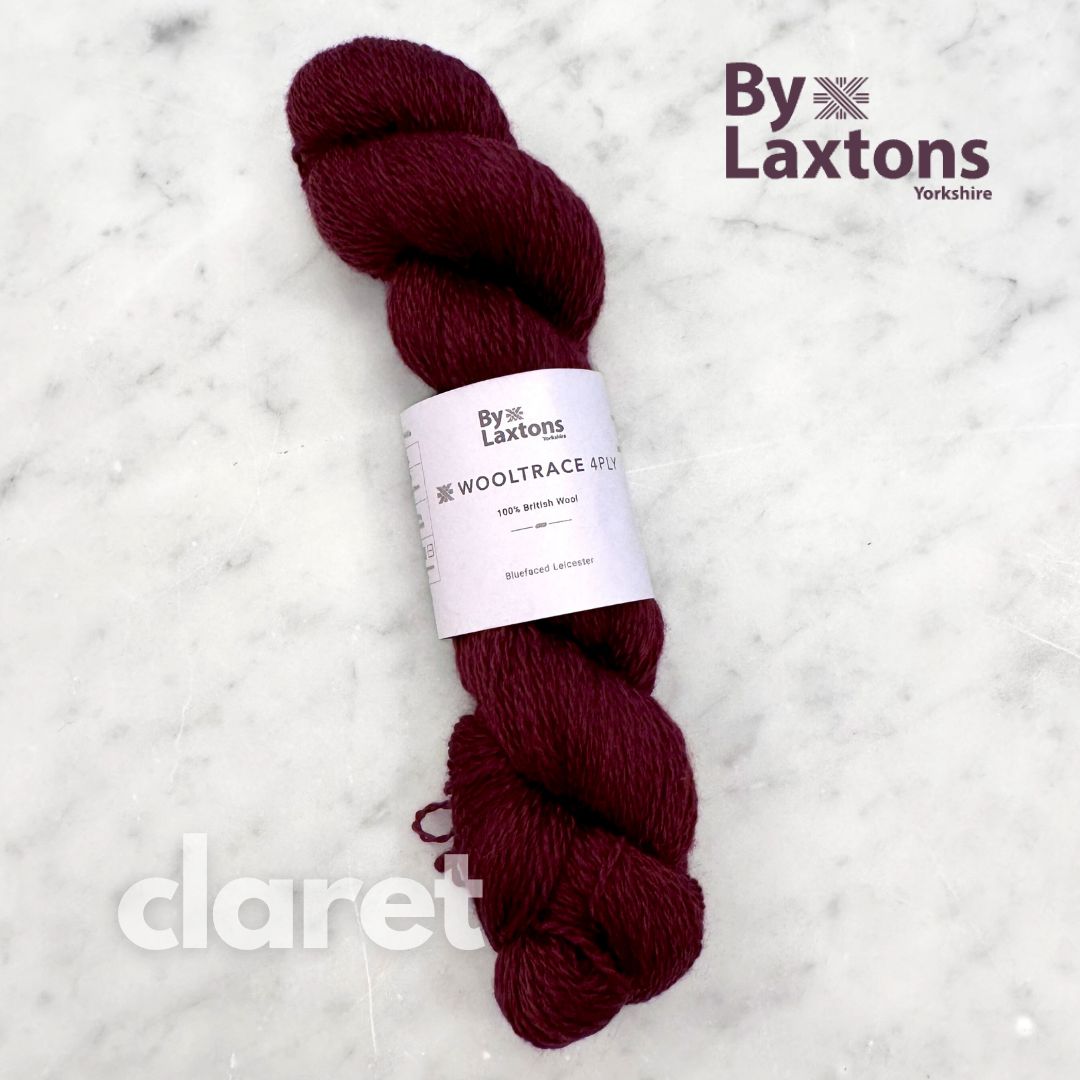 Claret-colored yarn skein with By Laxtons label on a white background