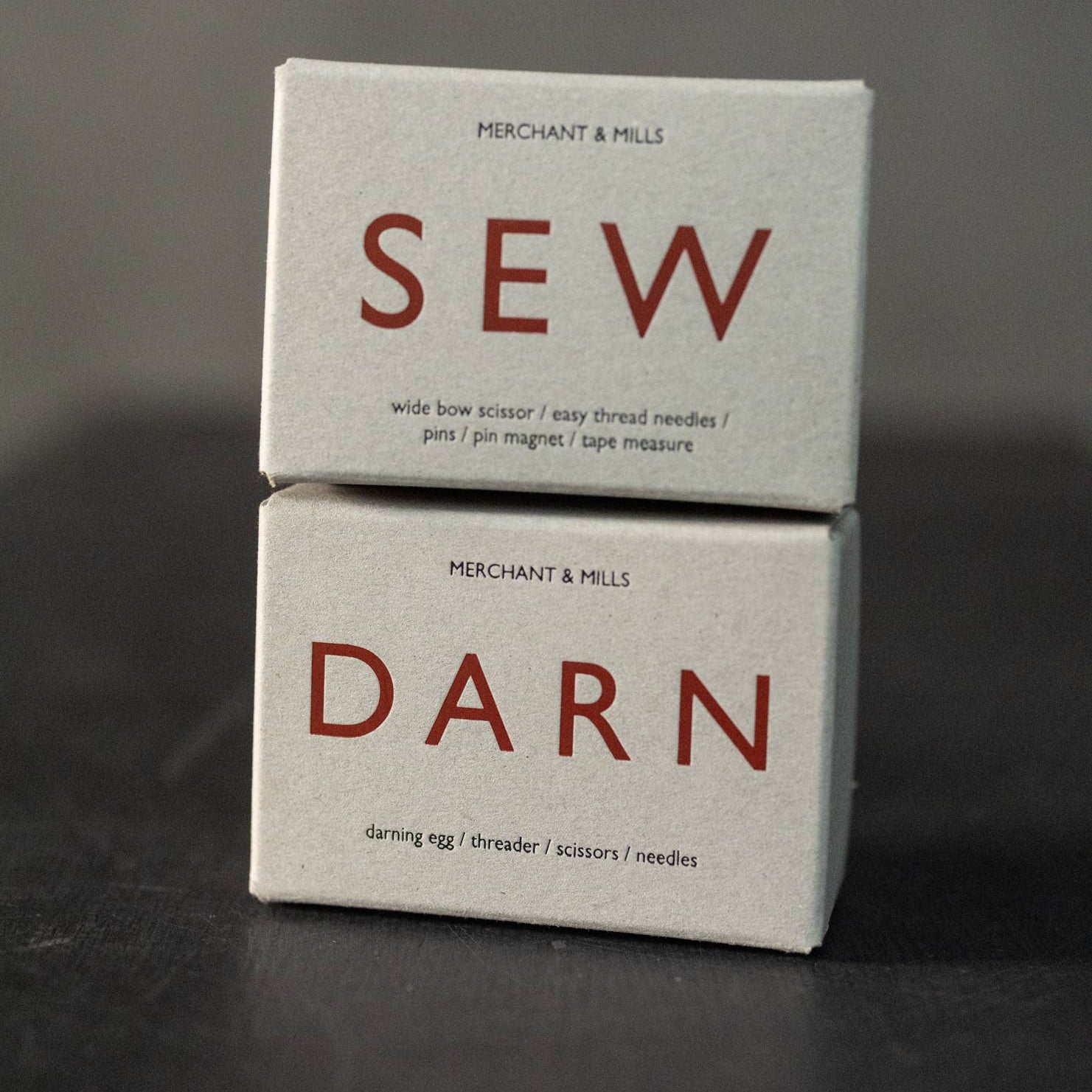 Two stacked boxes labeled 'SEW' and 'DARN' on a dark background
