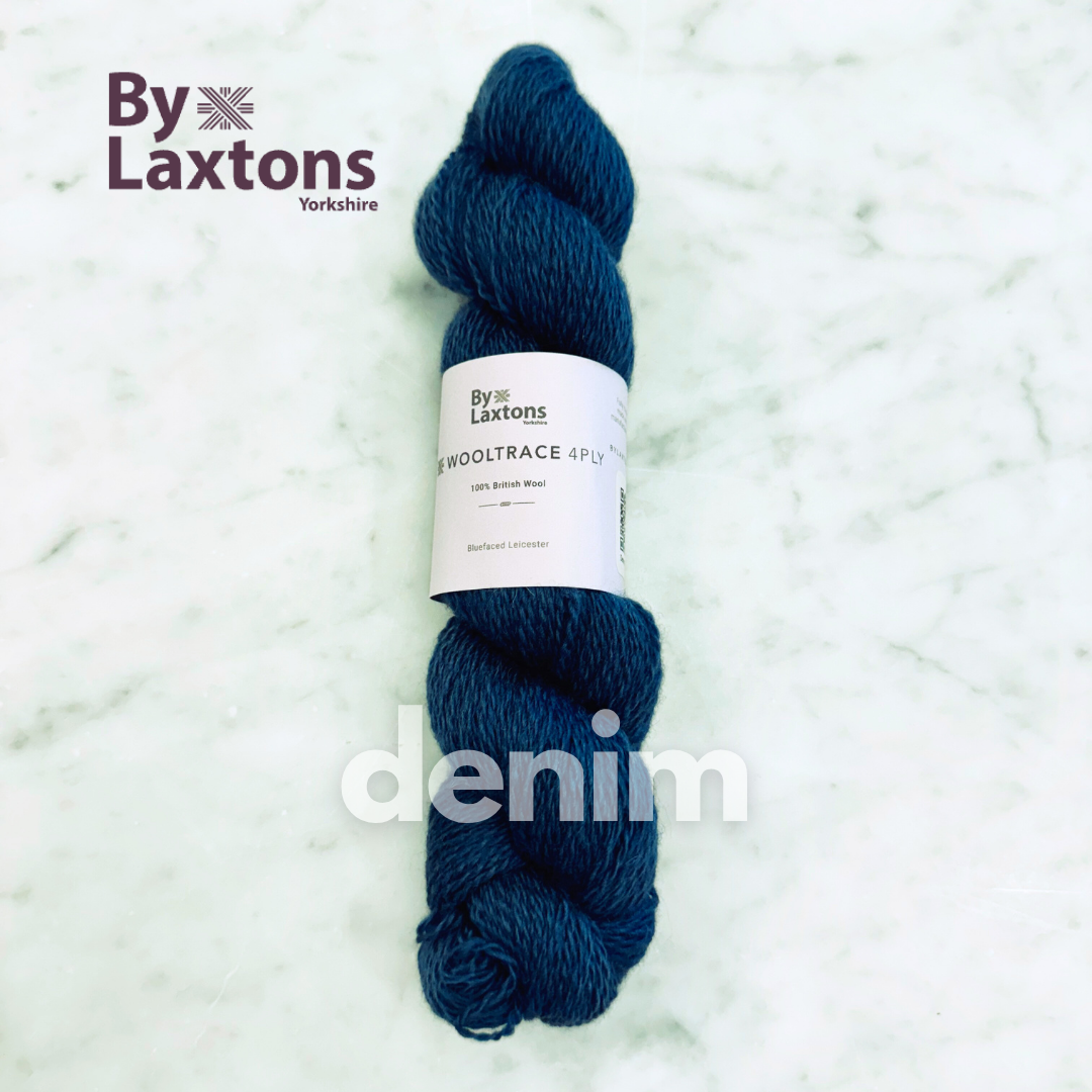 Denim blue skein of yarn with By Laxtons label on a light gray background