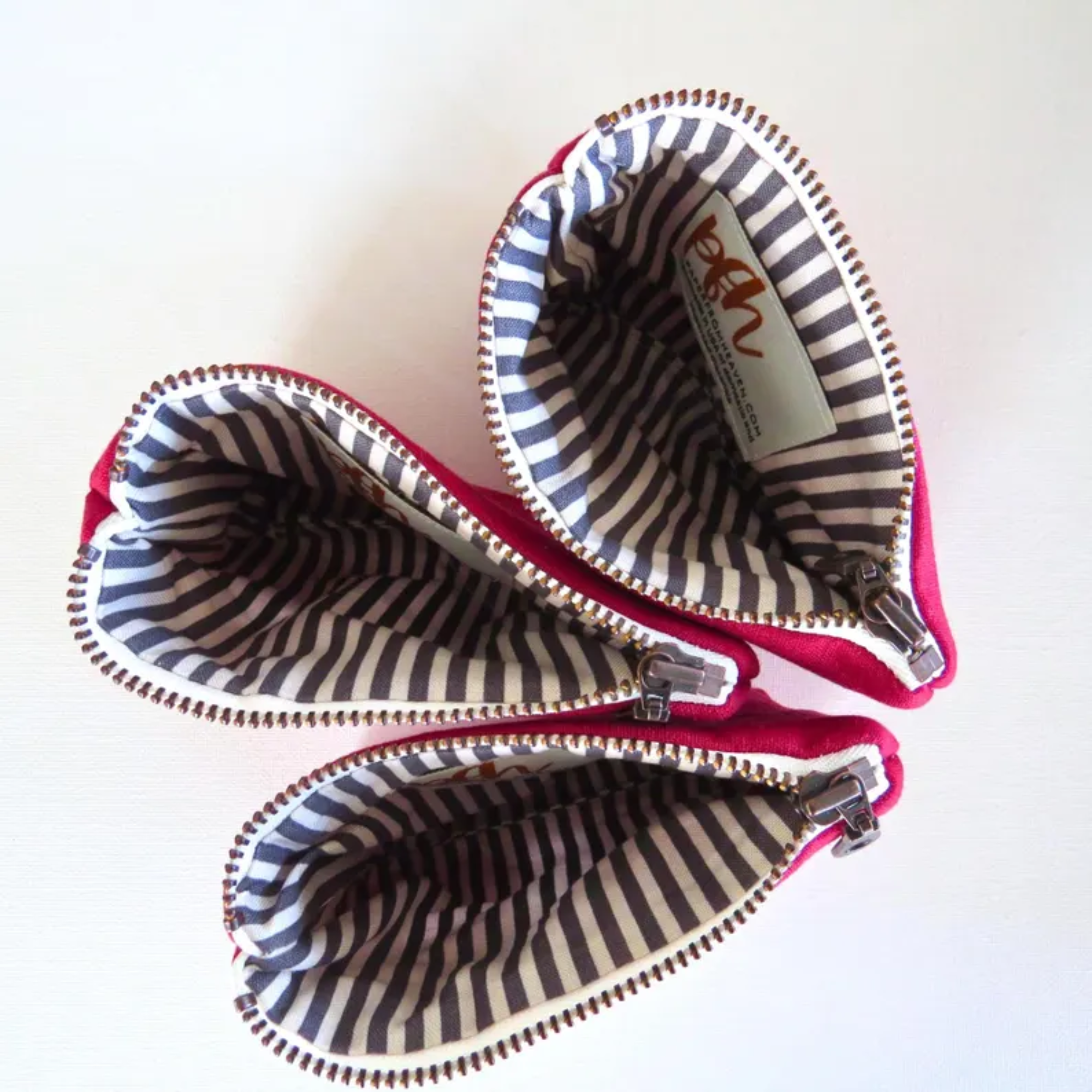 Two striped pouches with a visible brand label on a white background