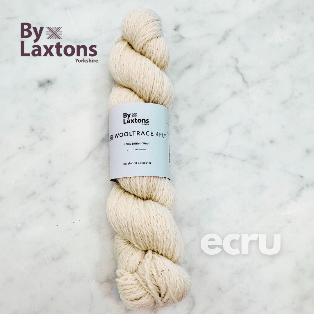 Ecru skein of yarn with By Laxtons label on a marble background