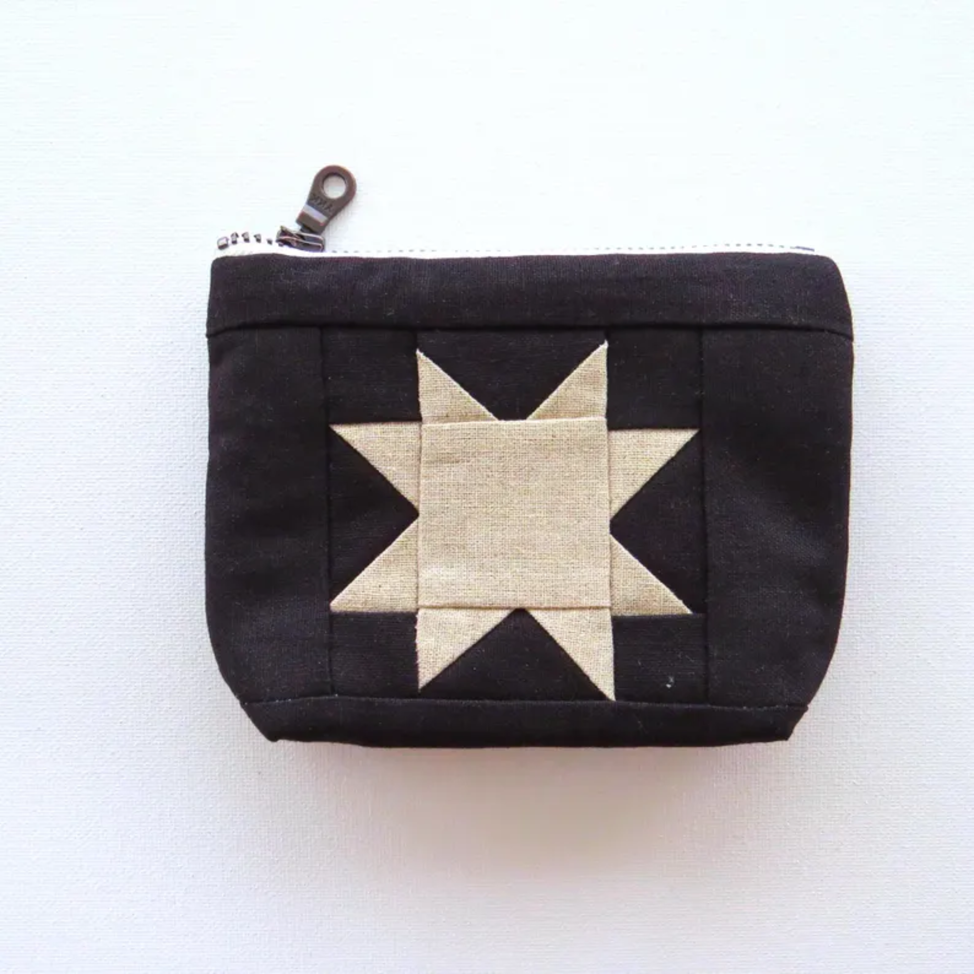 Black pouch with a star design on a white background