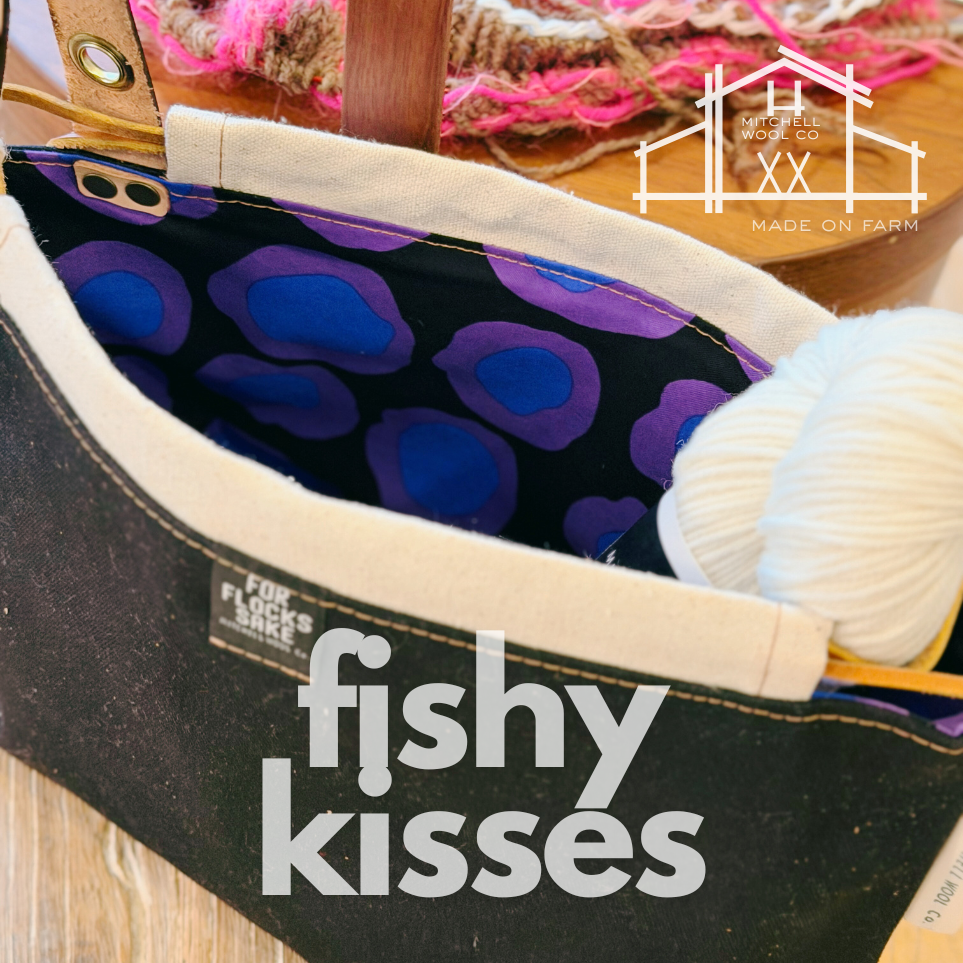 Black bag with purple and blue patterned interior, yarn, and 'fishy kisses' text.