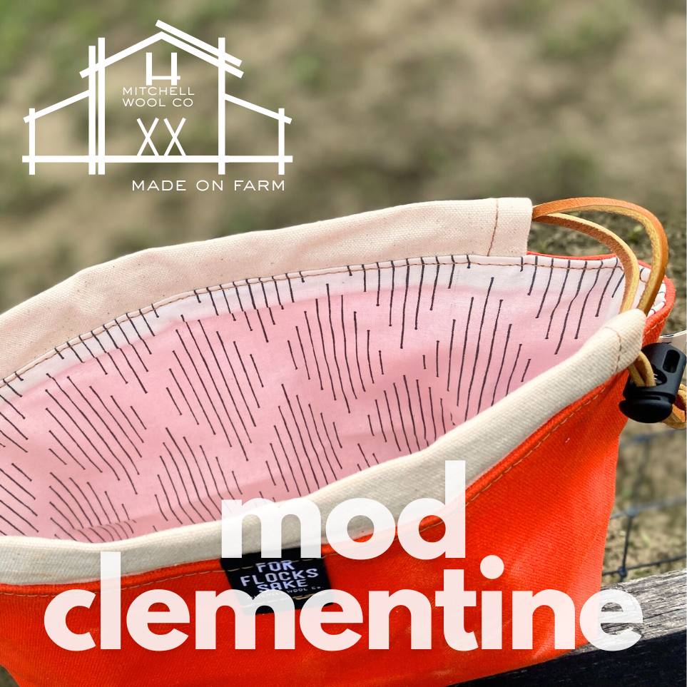 orange waxed cotton project bag with cream & black interior and 'mod clementine' text, Mitchell Wool Co logo above.