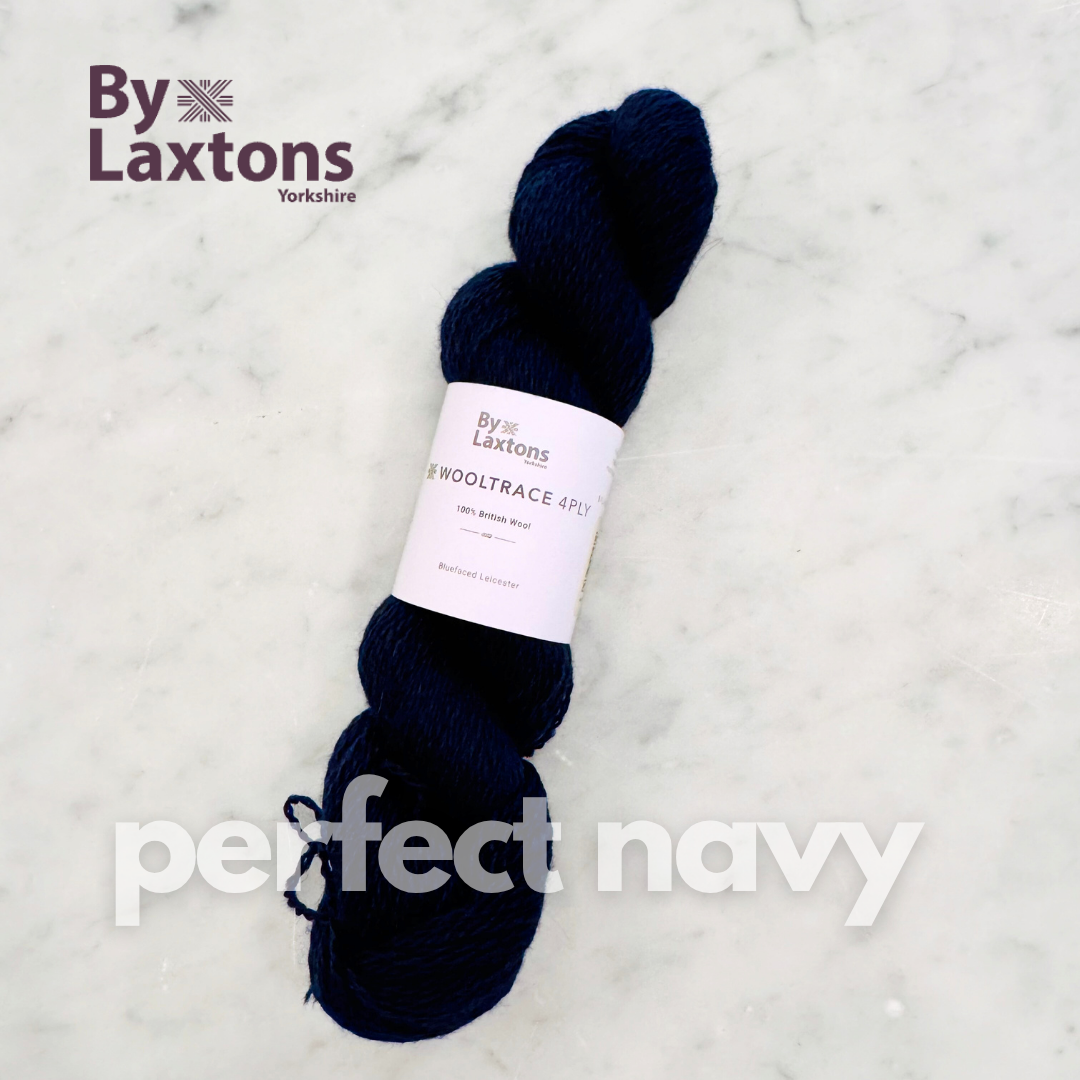 Navy yarn skein with By Laxtons label on a light gray background