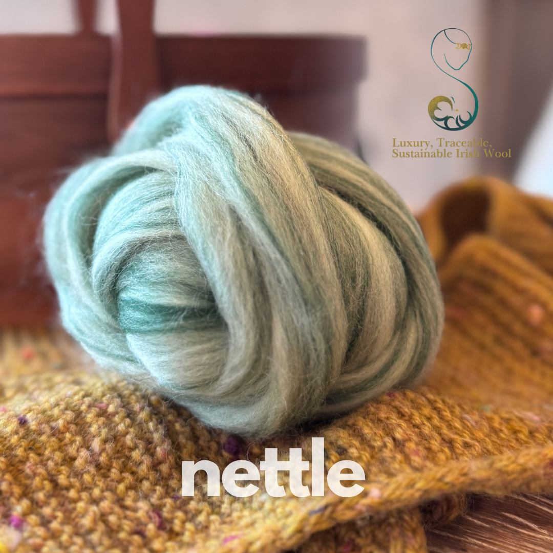 Light greyish green dollup of combed top from BFL Irish sheep with 'nettle' branding on a textured surface