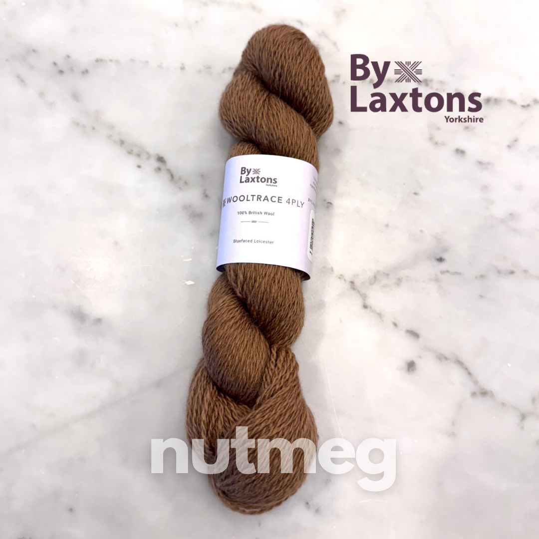 Brown skein of yarn with a By Laxttons label on a marble background