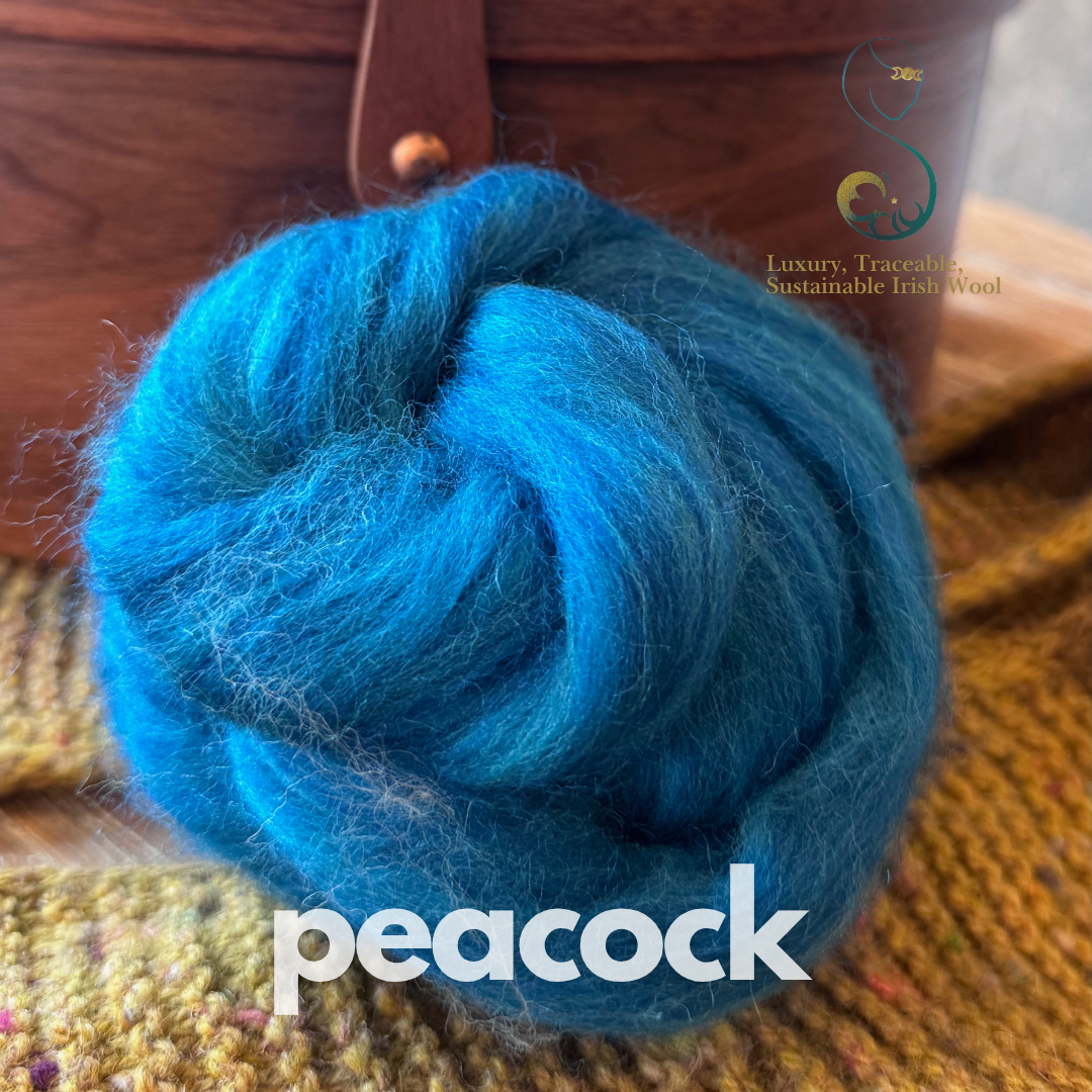 Blue dollup of combed top from BFL Irish sheep on a textured surface with 'peacock' branding.