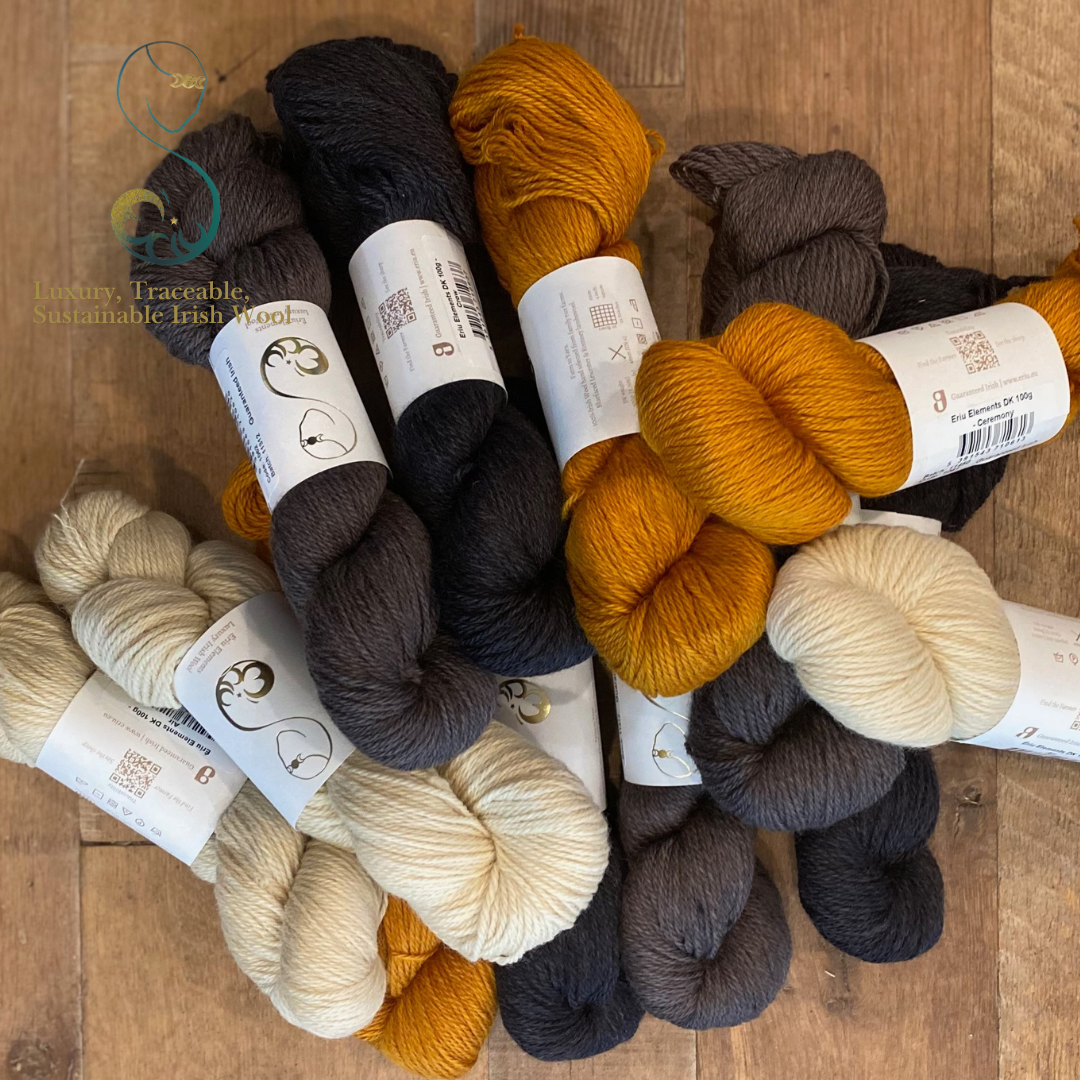 Collection of IRL BFL yarn skeins in various colors on a wooden surface