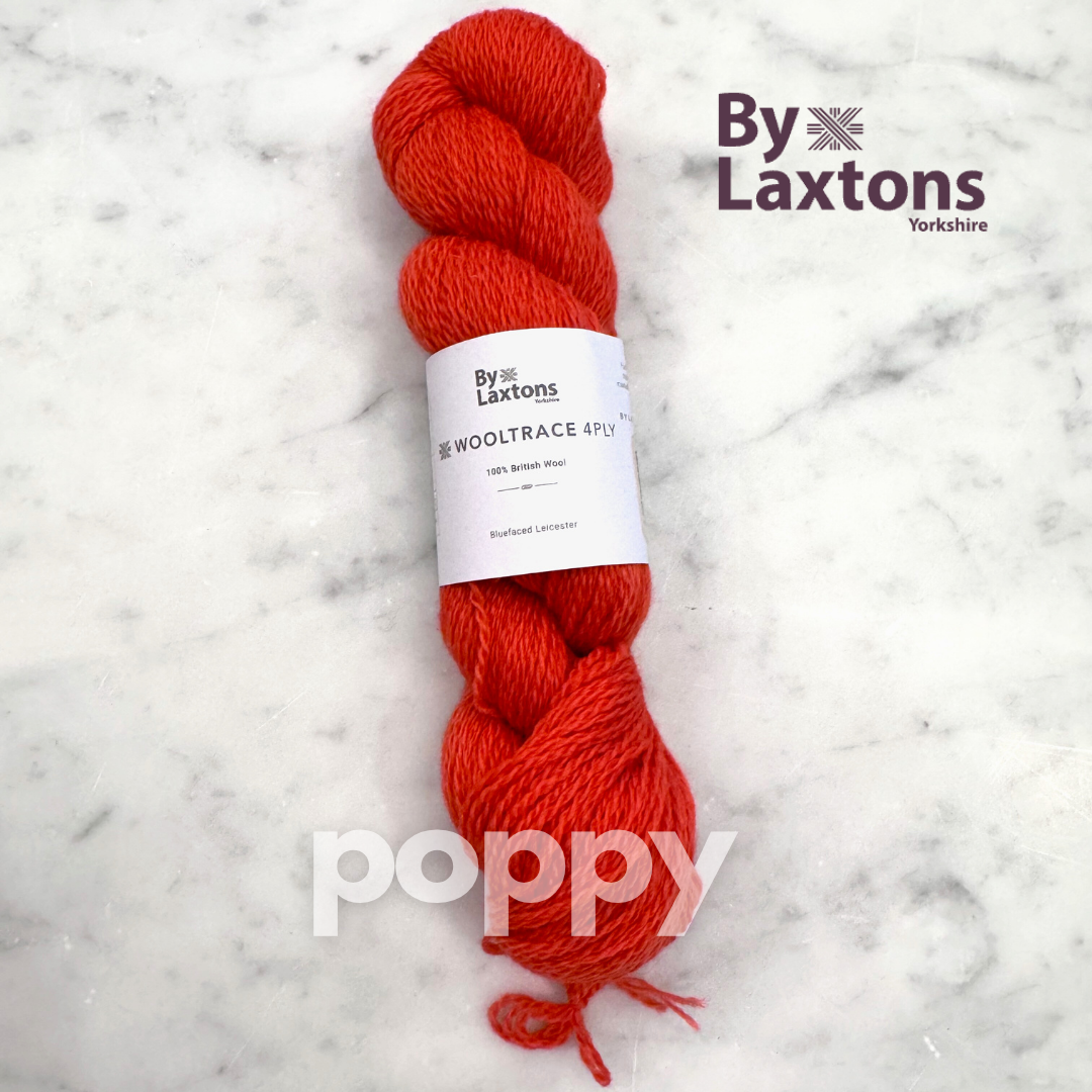 Poppy orange/red skein of yarn with a By Laxtons label on a marble background