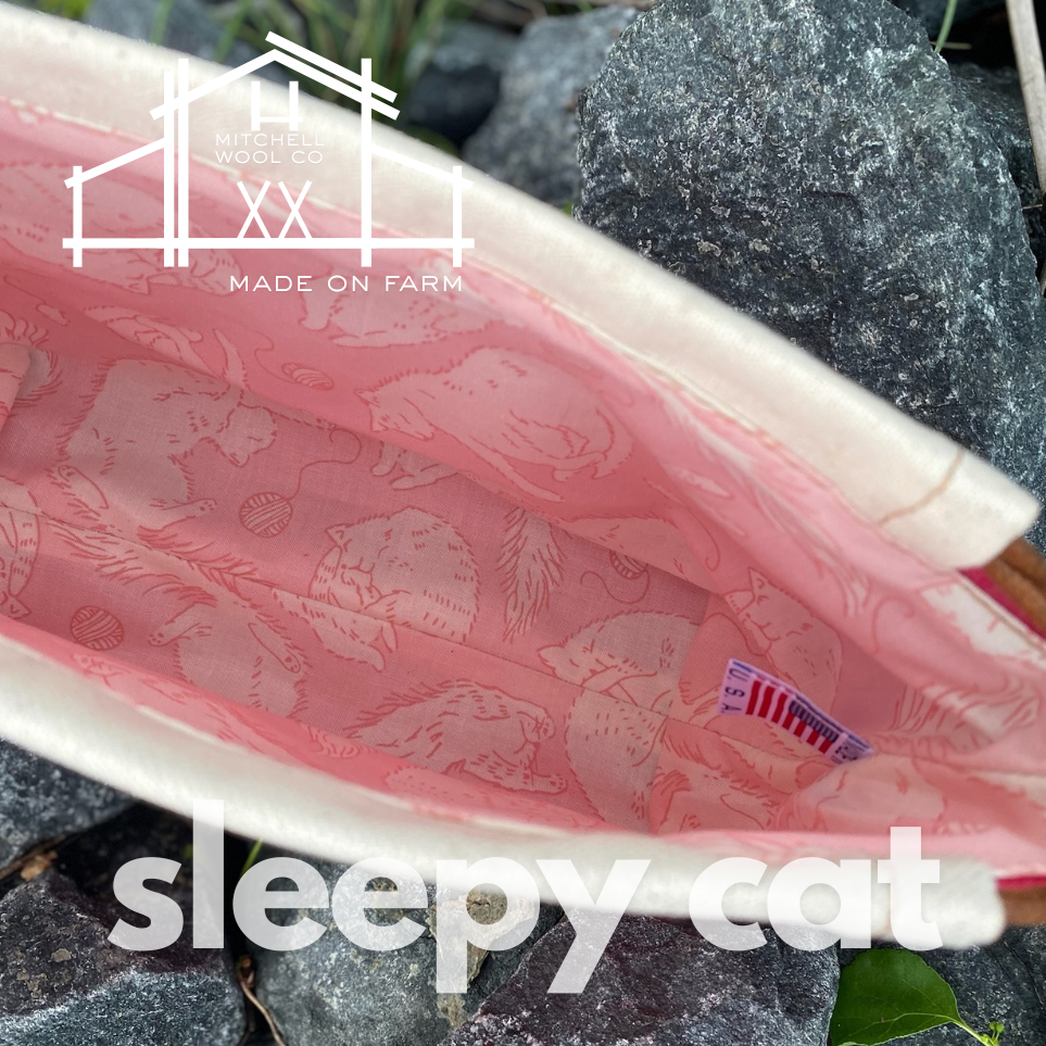 Pink patterned project bag with 'sleepy cat' text on a stone surface, featuring the 'Kitchener Wool Co.' logo.